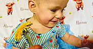Alena is registered to the contest to win money with this photo: toddler, child, flower, dandelion, dress, blue, striped, pattern, strawberry, blanket, calf, animal_print, smiling, happy, indoor, person, cute, sitting, baby, portrait