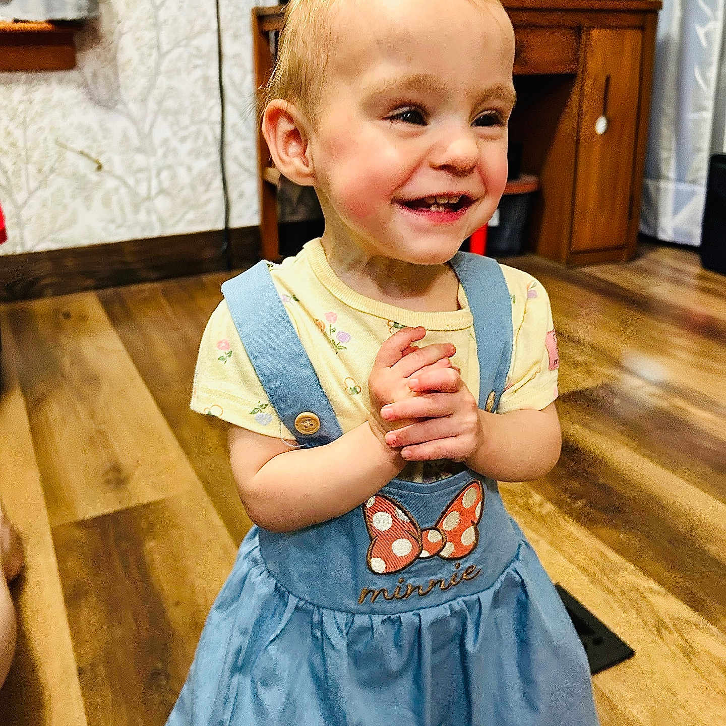 Alena joined the competition — help win amazing prizes! toddler, child, smiling, happy, blue_dress, minnie_mouse, clapping, indoor, wooden_floor, furniture, cabinet, curtains, person, cute, young_child, short_hair, playful, home, portrait, clothing