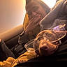 Alba participe au concours pour gagner de l'argent avec cette photo : dog, person, goggles, protective_eyewear, sleeping, relaxed, seated, closeup, portrait, warm_lighting, indoor, vehicle, seat, leather, humor, pet, brown_dog, human_face, casual, photography