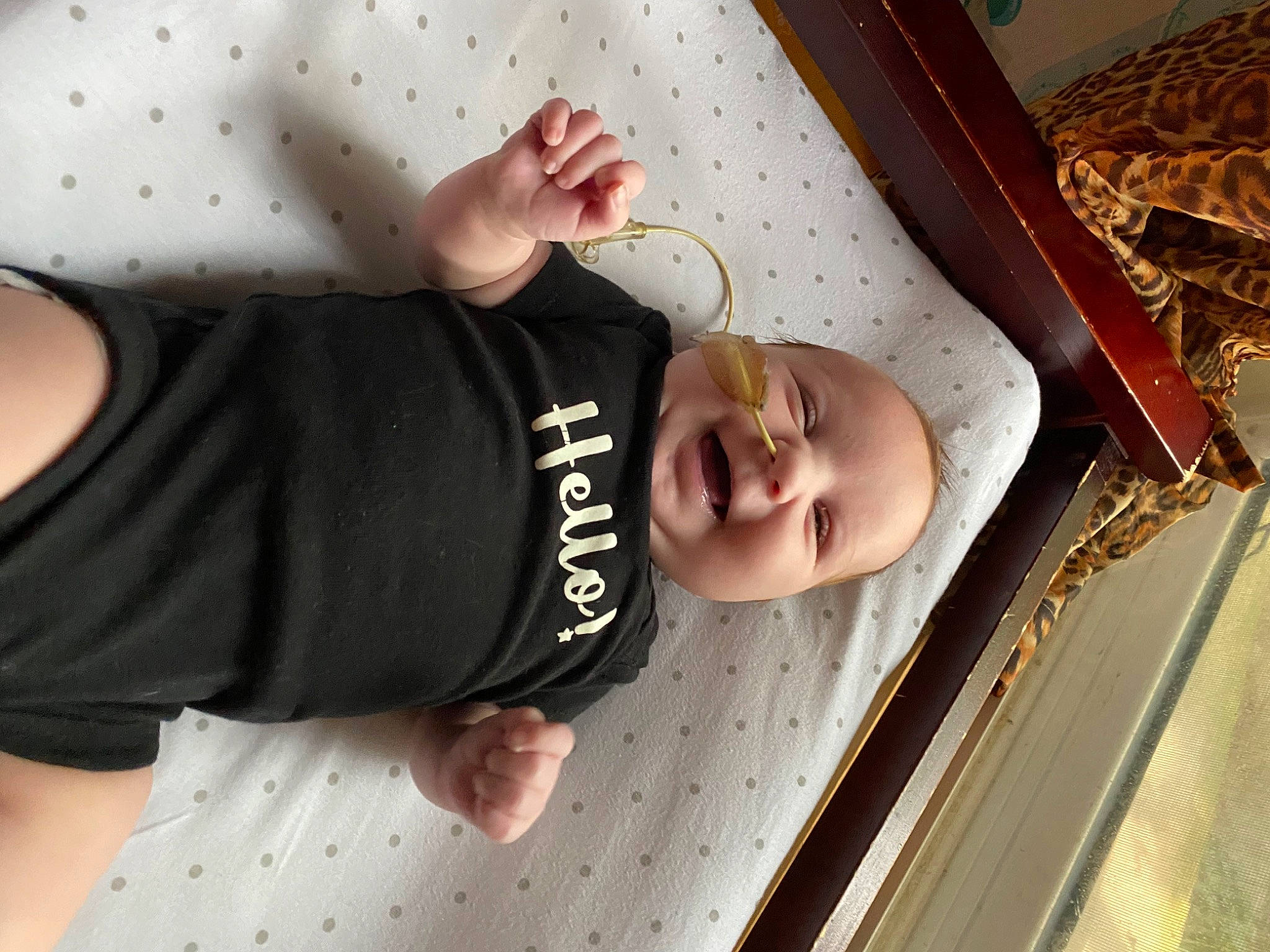 Ava is registered to the contest to win money with this photo: baby, baby_products, baby_safety, baby_toddler_clothing, child, comfort, elbow, flooring, fun, gesture, happy, pattern, person, skin, sleeve, smile, t_shirt, thumb, toddler, wood