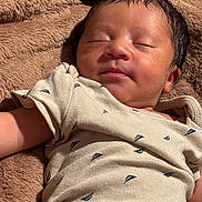Jett joined the competition — help win amazing prizes! newborn, baby, sleeping, peaceful, portrait, face, infant, onesie, clothing, blanket, plush, brown, cozy, indoors, close_up, resting, head, eyes_closed, warm_lighting, photography
