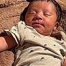 newborn, baby, sleeping, peaceful, portrait, face, infant, onesie, clothing, blanket, plush, brown, cozy, indoors, close_up, resting, head, eyes_closed, warm_lighting, photography