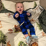 Ivan joined the competition — help win amazing prizes! baby, child, smiling, blue_clothing, onesie, bedspread, animal_print, rabbit, deer, mushroom, pine_tree, indoor, person, happy, lying_down, sock, cozy, nature_theme, cute, infant