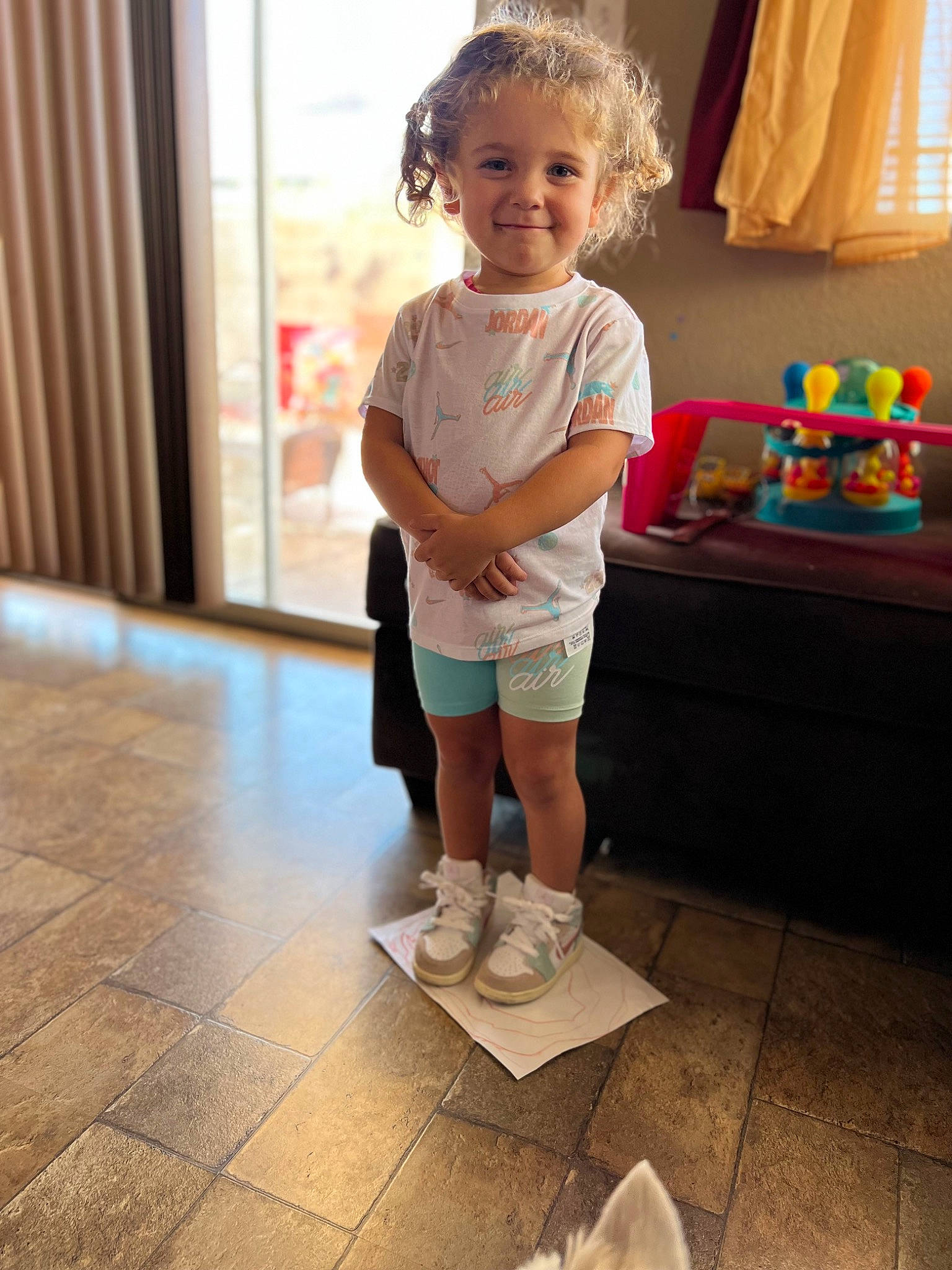 Jessie joined the competition — help win amazing prizes! baby_toddler_clothing, calf, child, curtain, event, flooring, fun, hair, happy, head, human_leg, joy, knee, leisure, person, shorts, smile, standing, t_shirt, table