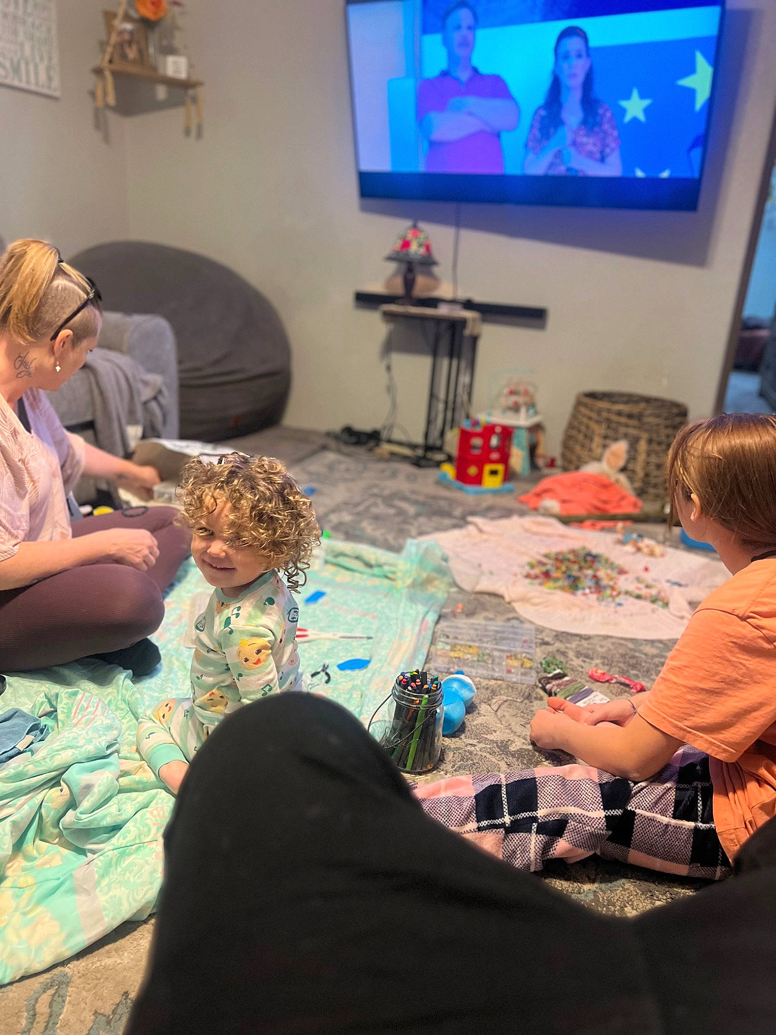 Jessie joined the competition — help win amazing prizes! blurred, community, conversation, couch, display_device, electronic_device, entertainment, event, fun, human, interaction, joy, leisure, lighting, person, room, sharing, social_group, t_shirt, table