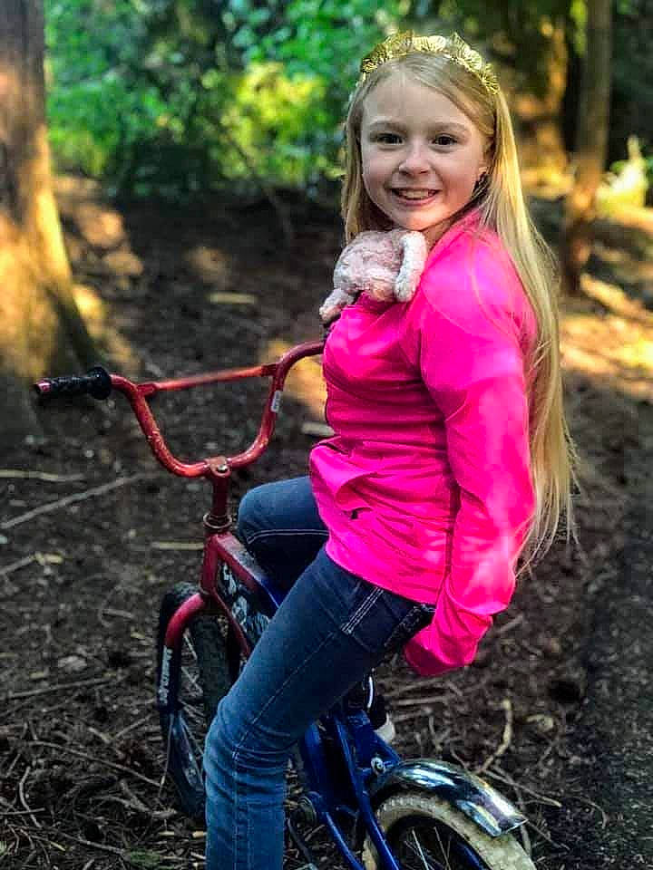 Caylee is registered to the contest to win money with this photo: automotive_tire, bicycle, bicycle_frame, bicycle_handlebar, bicycle_tire, bicycle_wheel, bicycles_equipment_and_supplies, clothing, eye, face, facial_expression, hair, hairstyle, head, jeans, joy, people_in_nature, person, plant, smile