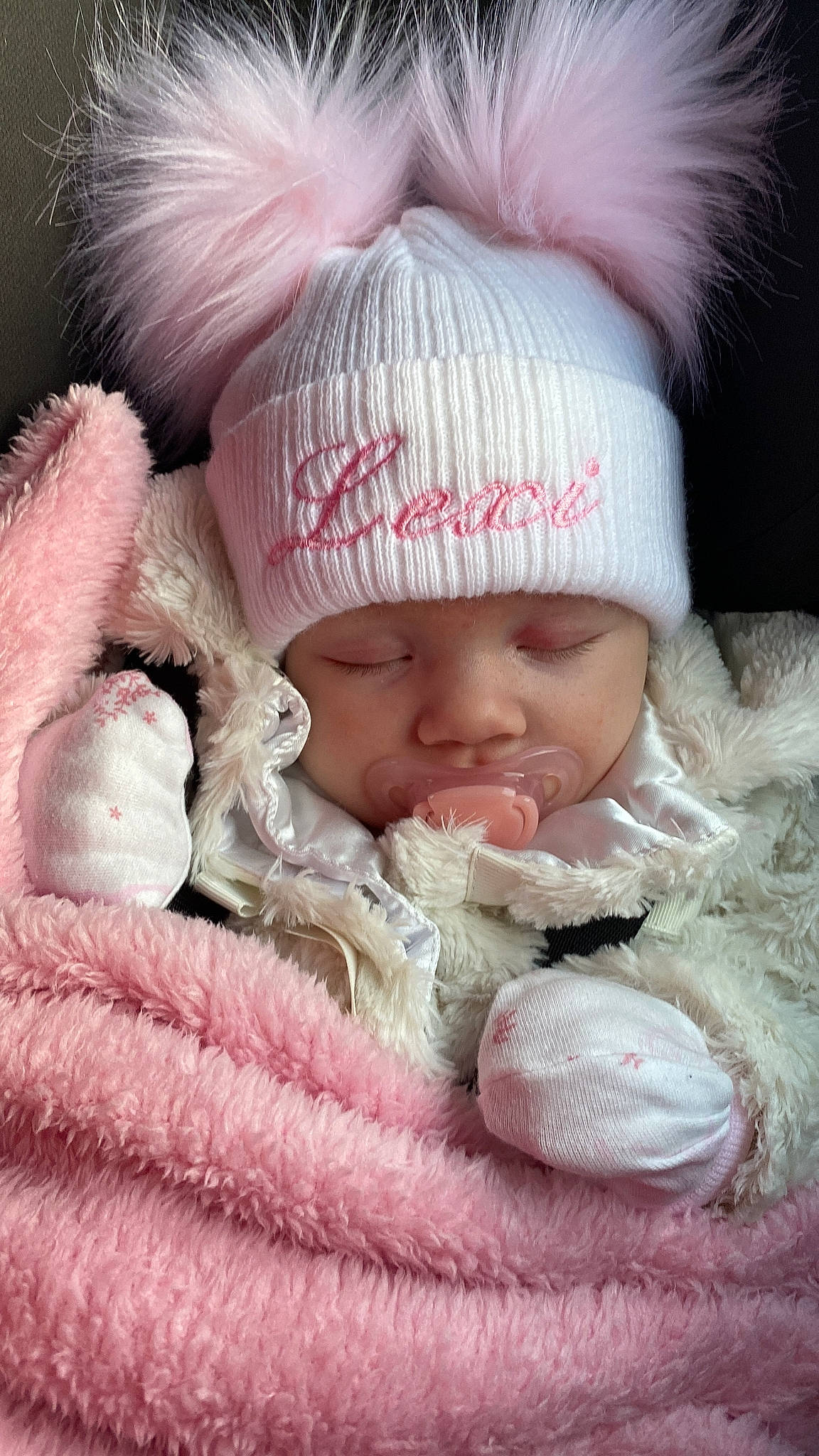 Lexi is registered to the contest to win money with this photo: baby, baby_sleeping, cap, cheek, child, comfort, eye, face, fur, headgear, headwear, knit_cap, linens, lip, outerwear, person, pink, skin, textile, toddler