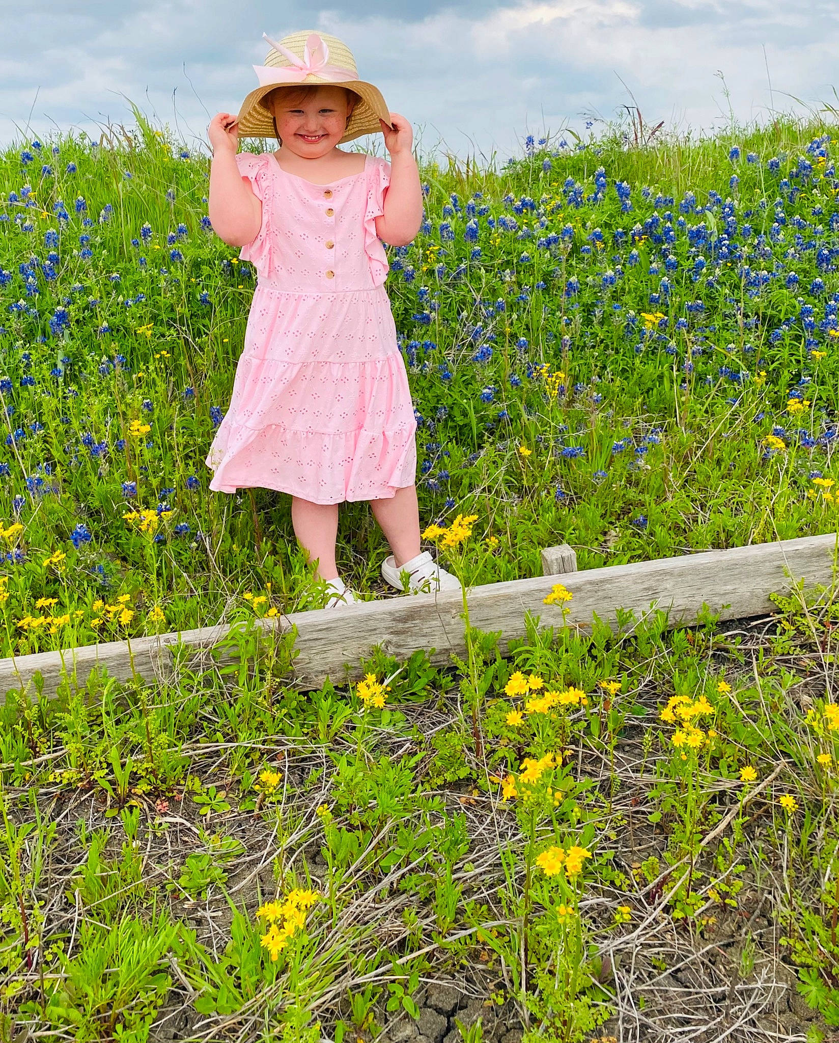 Ashlynn is registered to the contest to win money with this photo: agriculture, cloud, day_dress, dress, field, flower, flowering_plant, grass, grass_family, grassland, groundcover, happy, hat, headwear, joy, meadow, people_in_nature, person, plant, prairie