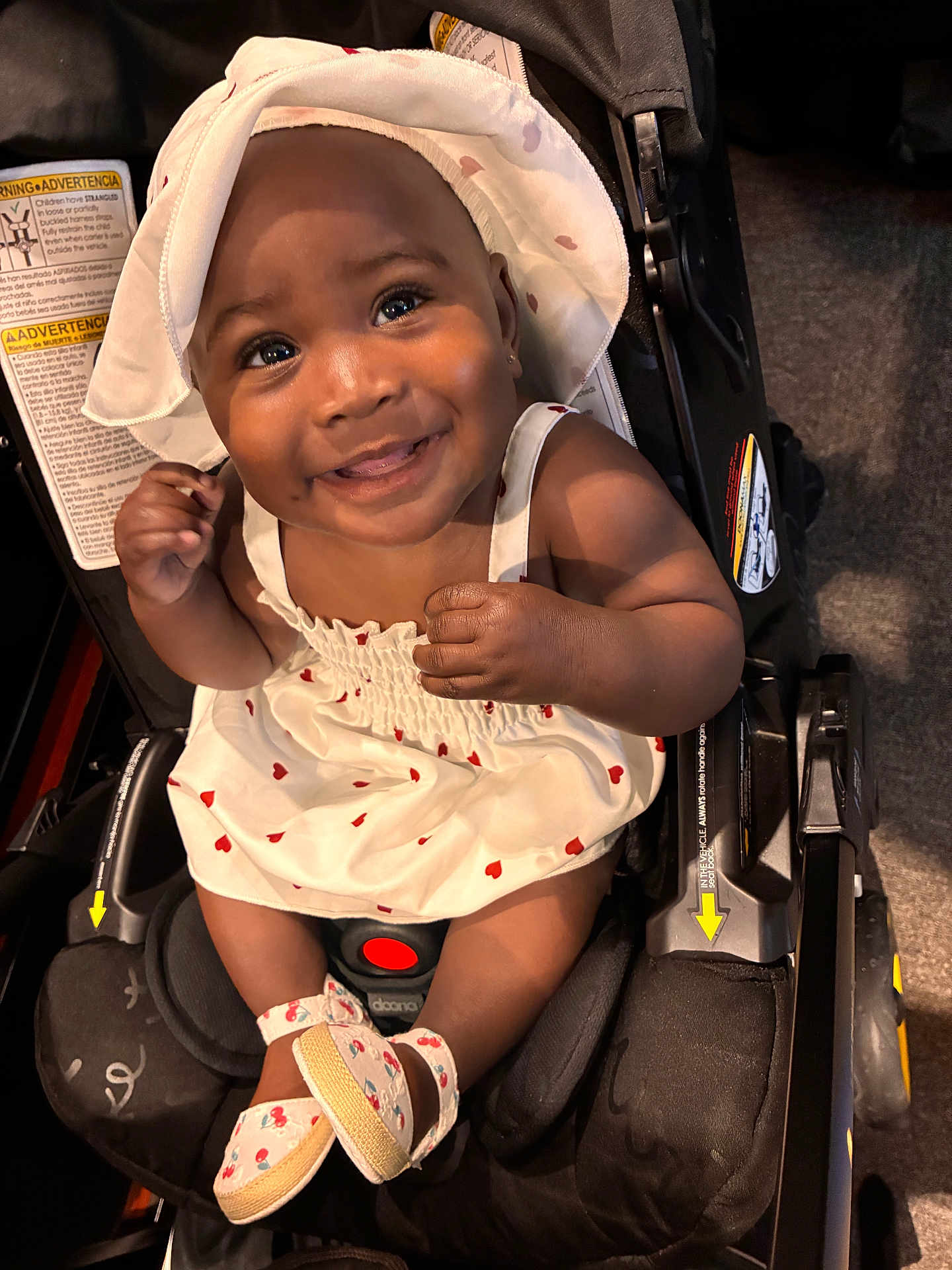 Eden is registered to the contest to win money with this photo: baby, child, smiling, dress, hat, stroller, footwear, infant, cute, happy, portrait, indoors, seat, person, fashion, accessory, childrens_clothing, closeup, baby_shoes, sitting