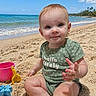 baby, beach, sand, ocean, sky, bucket, shovel, toys, child, green_clothing, sitting, sunny, water, waves, smiling, cute, outdoor, holiday, play, nature