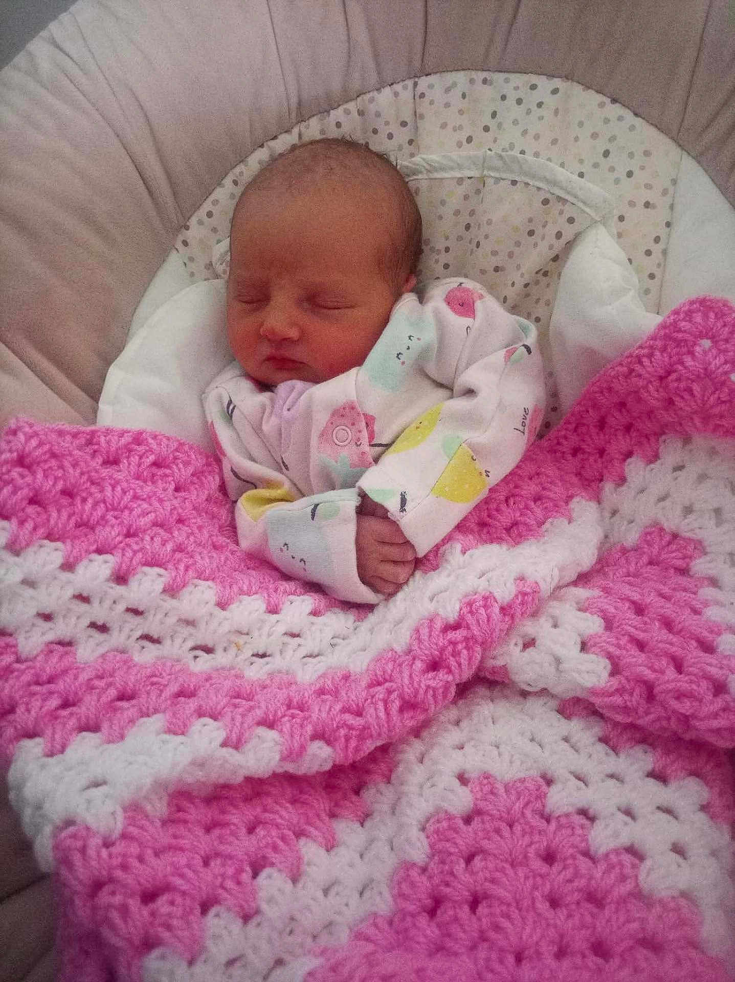 Summer is registered to the contest to win money with this photo: newborn, baby, sleeping, blanket, crocheted_blanket, pink, white, onesie, infant, cushion, baby_seat, peaceful, cozy, soft, handmade, child, portrait, indoors, cute, resting