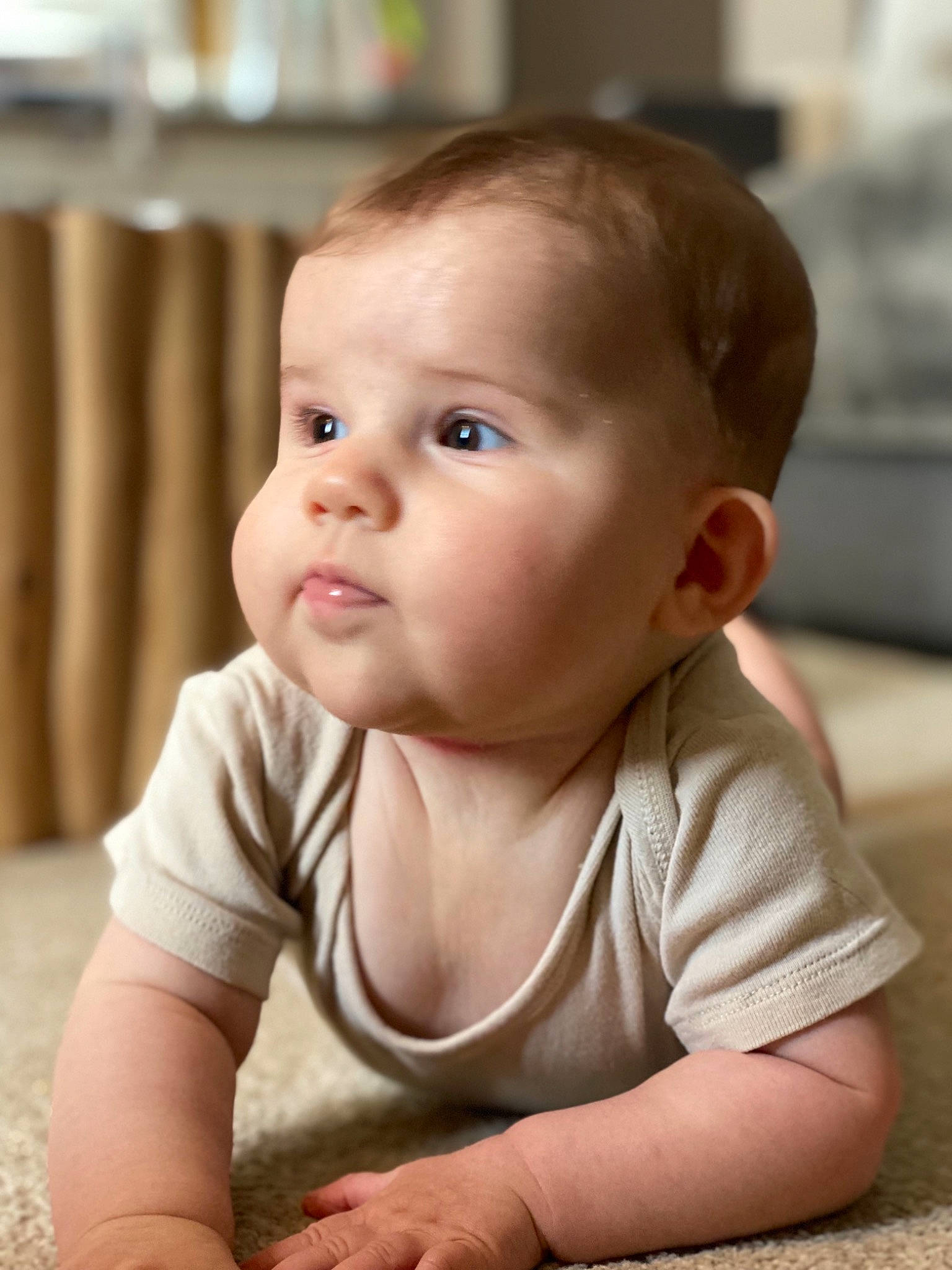Ilyana participe au concours pour gagner de l'argent avec cette photo : baby, baby_toddler_clothing, cheek, child, clothing, comfort, flooring, fun, happy, hardwood, iris, nose, person, portrait_photography, sitting, skin, sleeve, smile, t_shirt, toddler