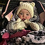 Violet joined the competition — help win amazing prizes! baby, child, stroller, hat, mittens, blanket, coat, outdoor, night, warm_clothing, cute, face, person, fur_texture, bundle, cold_weather, infant, cozy, seated, portrait