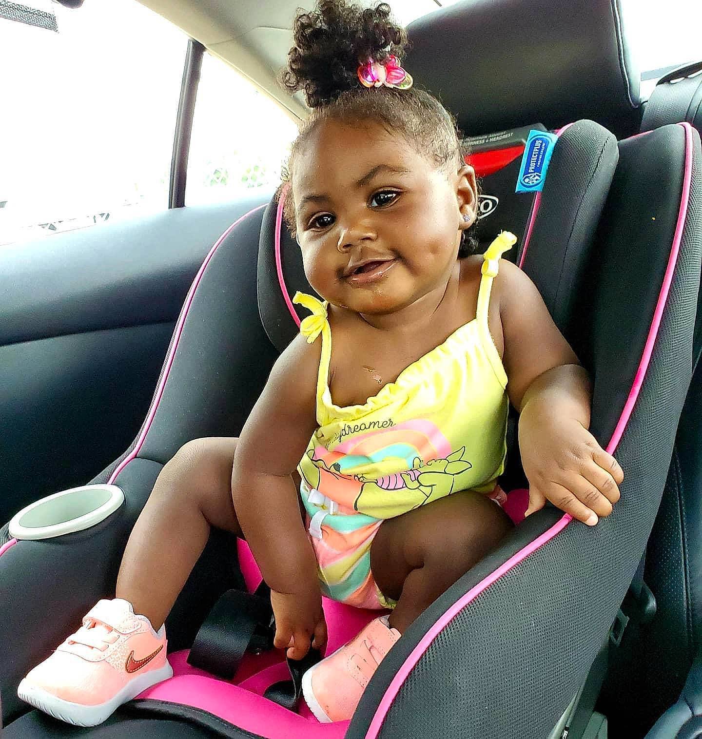 Journee joined the competition — help win amazing prizes! auto_part, baby_in_car_seat, black_hair, car, car_seat, car_seat_cover, child, family_car, joy, person, pink, seat_belt, sitting, smile, toddler, vacation, vehicle, vehicle_door