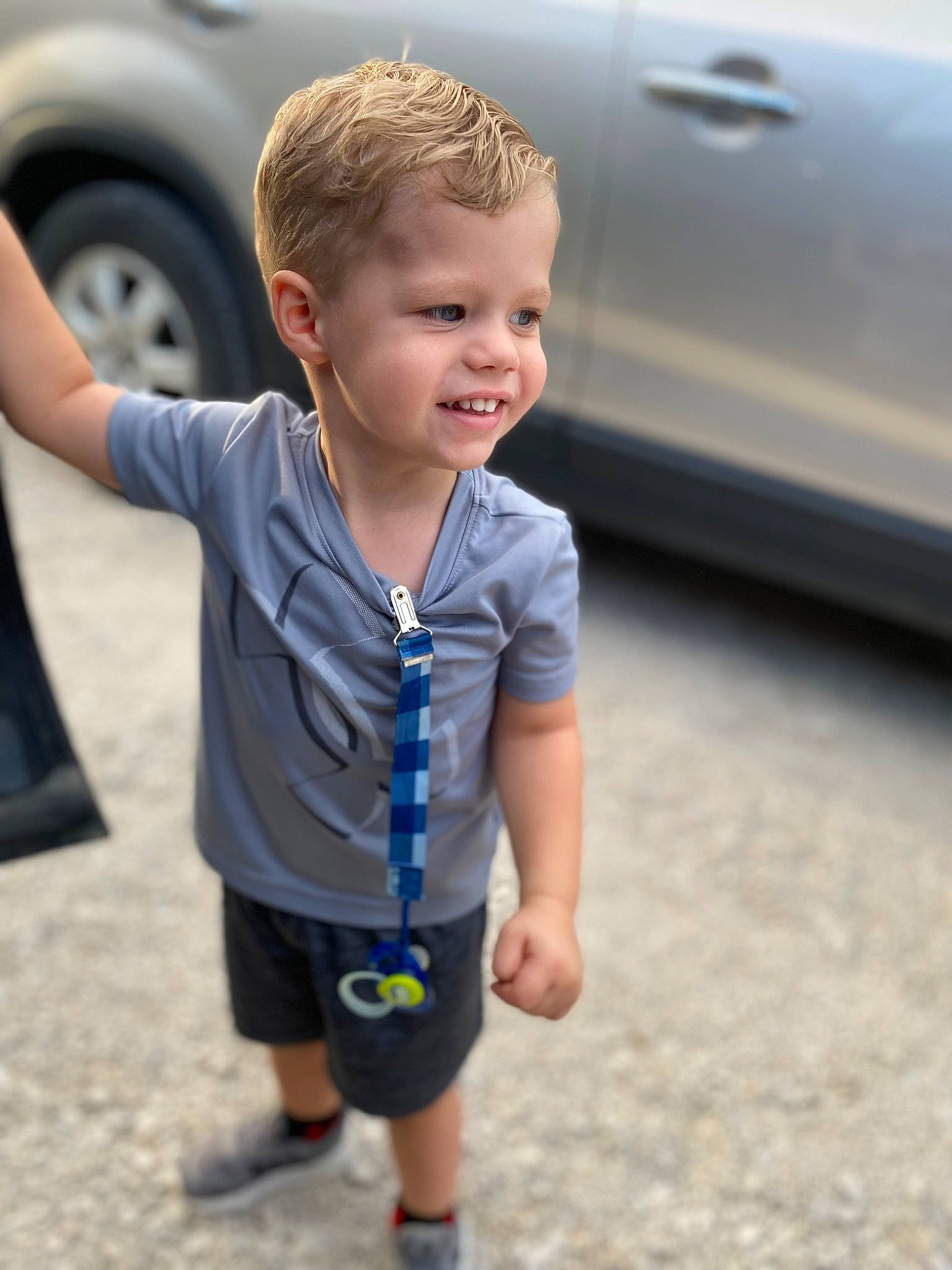 Westyn joined the competition — help win amazing prizes! asphalt, automotive_exterior, automotive_tire, bumper, car, child, electric_blue, family_car, fun, joy, parking, person, shorts, sleeve, smile, standing, t_shirt, tire, toddler, vehicle