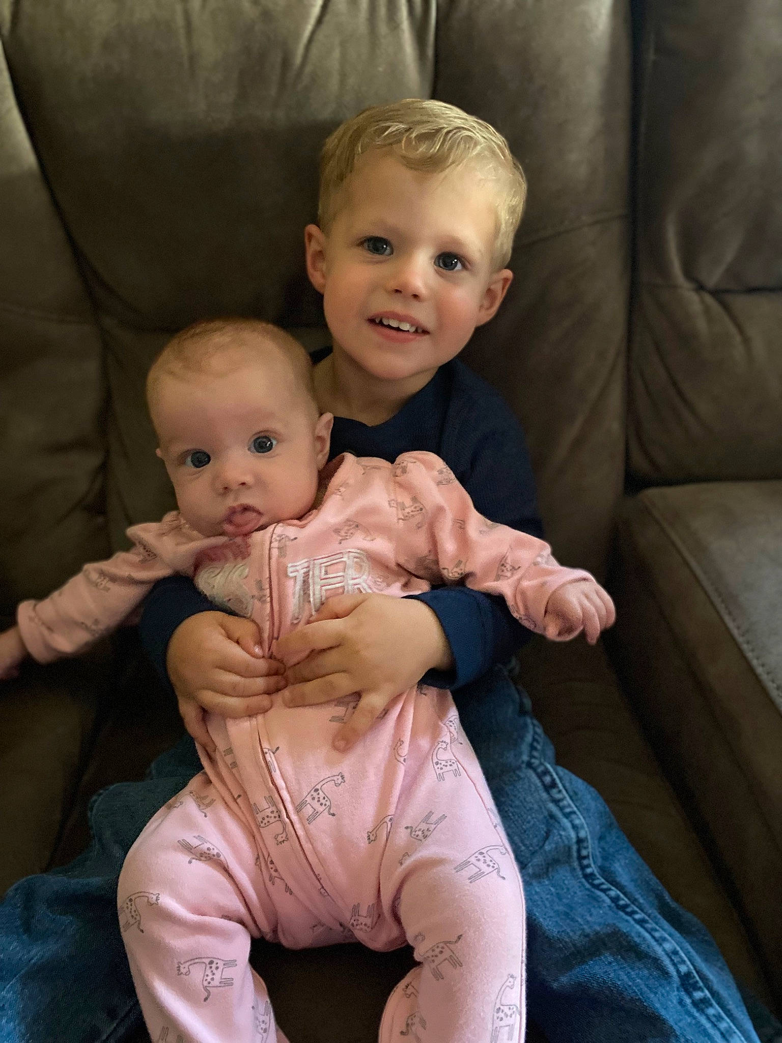 Westyn is registered to the contest to win money with this photo: baby_toddler_clothing, cheek, comfort, couch, eye, face, flash_photography, hair, hairstyle, happy, head, human_body, interaction, iris, joy, lap, leg, person, skin, sleeve