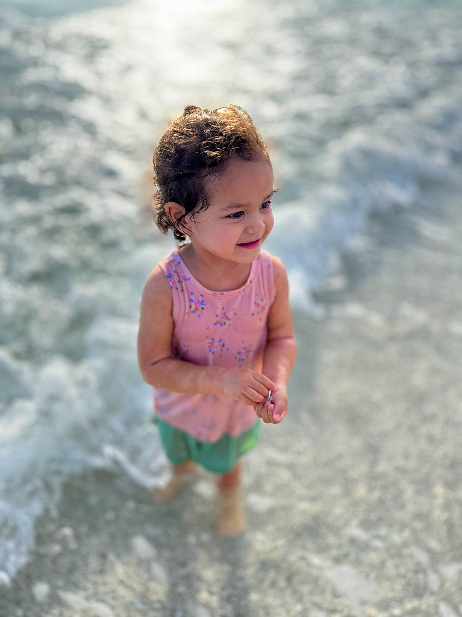 Vada is registered to the contest to win money with this photo: azure, baby, beach, body_of_water, eye, face, flash_photography, fun, gesture, happy, head, human_body, joy, leisure, people_in_nature, people_on_beach, person, sand, skin, smile