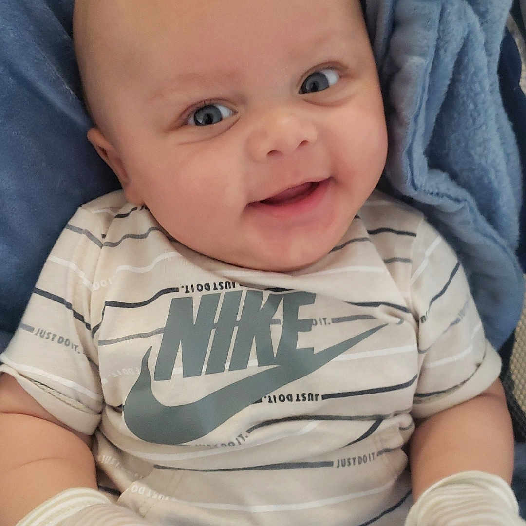 John joined the competition — help win amazing prizes! baby, bed, blanket, clothing, crib, cushion, face, furniture, glove, happy, head, homedecor, infantbed, newborn, pants, person, photography, portrait, smile, t_shirt