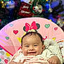 Arely joined the competition — help win amazing prizes! baby, smiling, blanket, baby_chair, minnie_mouse, pink, christmas_tree, ornaments, holiday, indoor, happy, child, cute, infant, soft_toy, colorful, face, person, cozy, festive