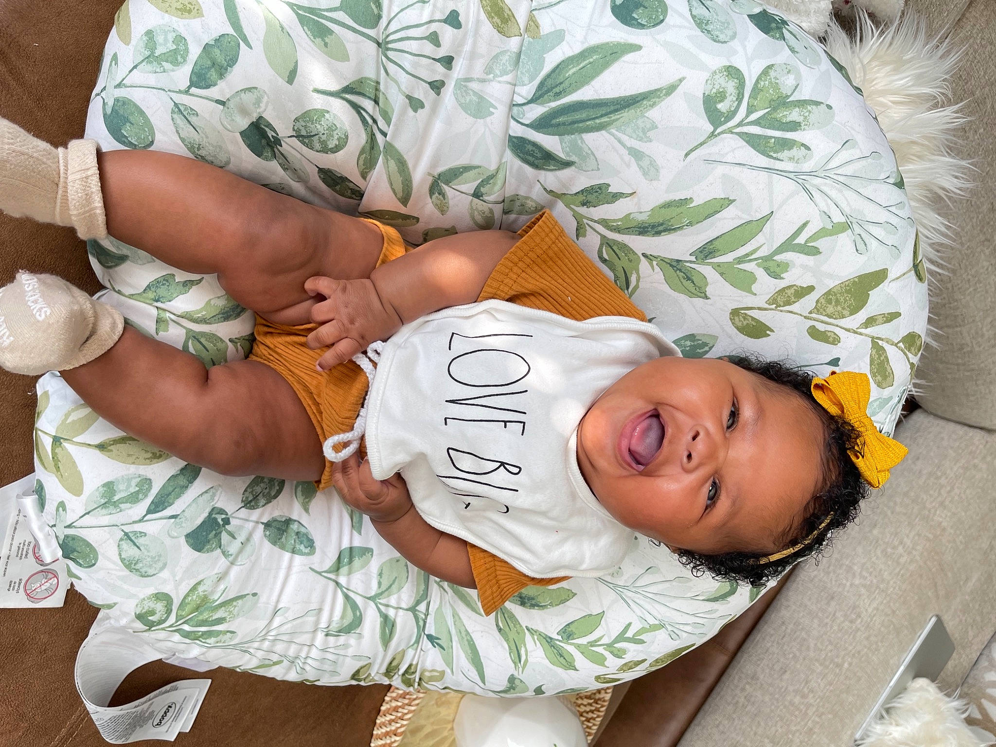 Nola is registered to the contest to win money with this photo: abdomen, baby, baby_toddler_clothing, child, comfort, elbow, finger, gesture, happy, hat, human_body, joint, pattern, person, sitting, skin, sleeve, smile, textile, toddler