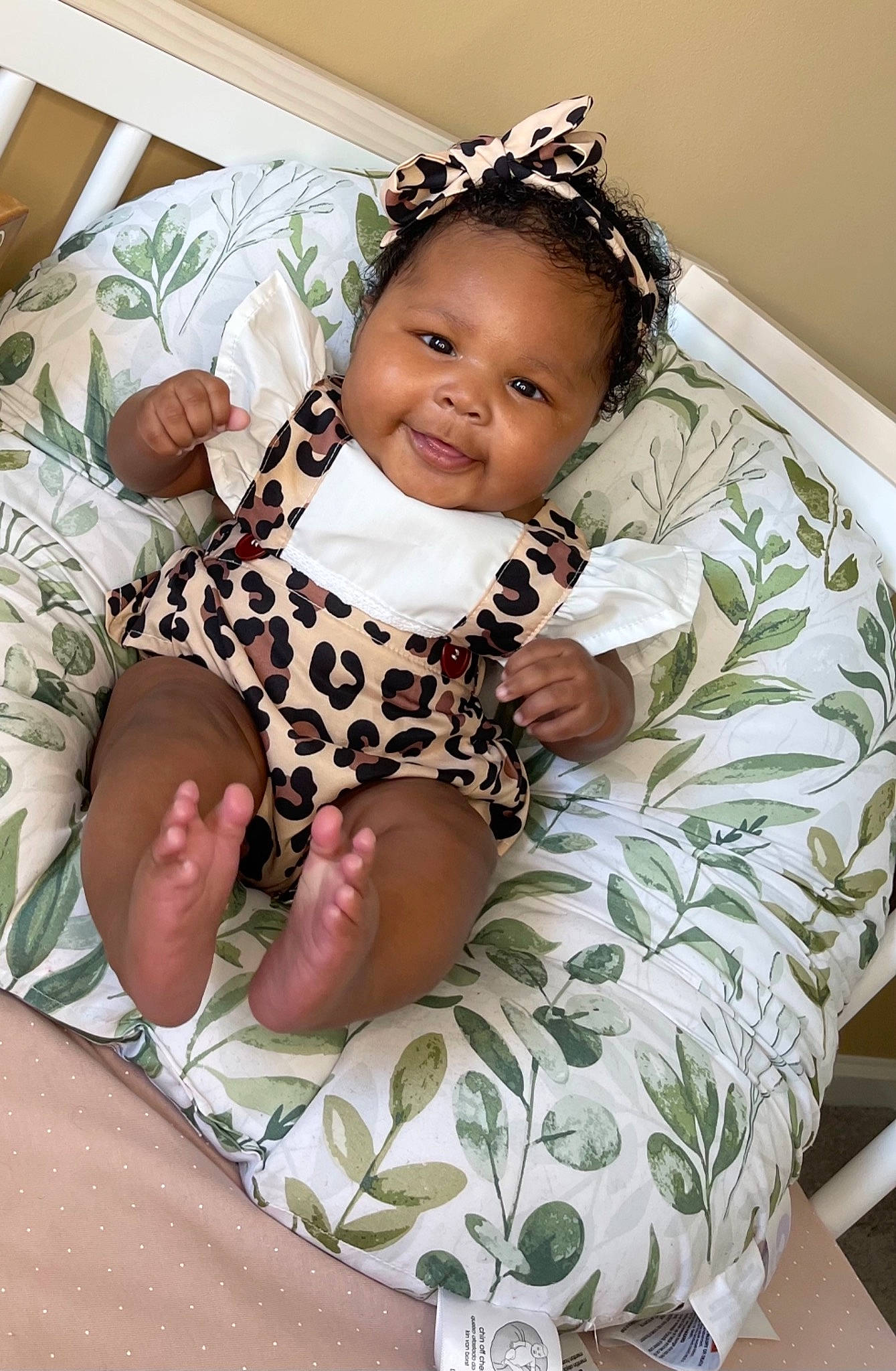Nola is registered to the contest to win money with this photo: baby, baby_products, baby_toddler_clothing, child, comfort, fashion_accessory, hairstyle, happy, headband, jewellery, joy, linens, military_camouflage, pattern, person, pink, sitting, skin, sleeve, textile