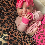 Jazlynn joined the competition — help win amazing prizes! baby, infant, pink_bow, headband, pink_clothing, leopard_print, blanket, cute, cheeks, fingers, hand, lying_down, pattern, animal_print, smiling, indoors, child, portrait, cozy, soft