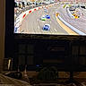 Sadie joined the competition — help win amazing prizes! car, cat, couch, dark, entertainment, fan, feline, furniture, indoor, living_room, pet, picture_frame, plant, race_track, relaxation, screen, spectator, sports, television, vehicle