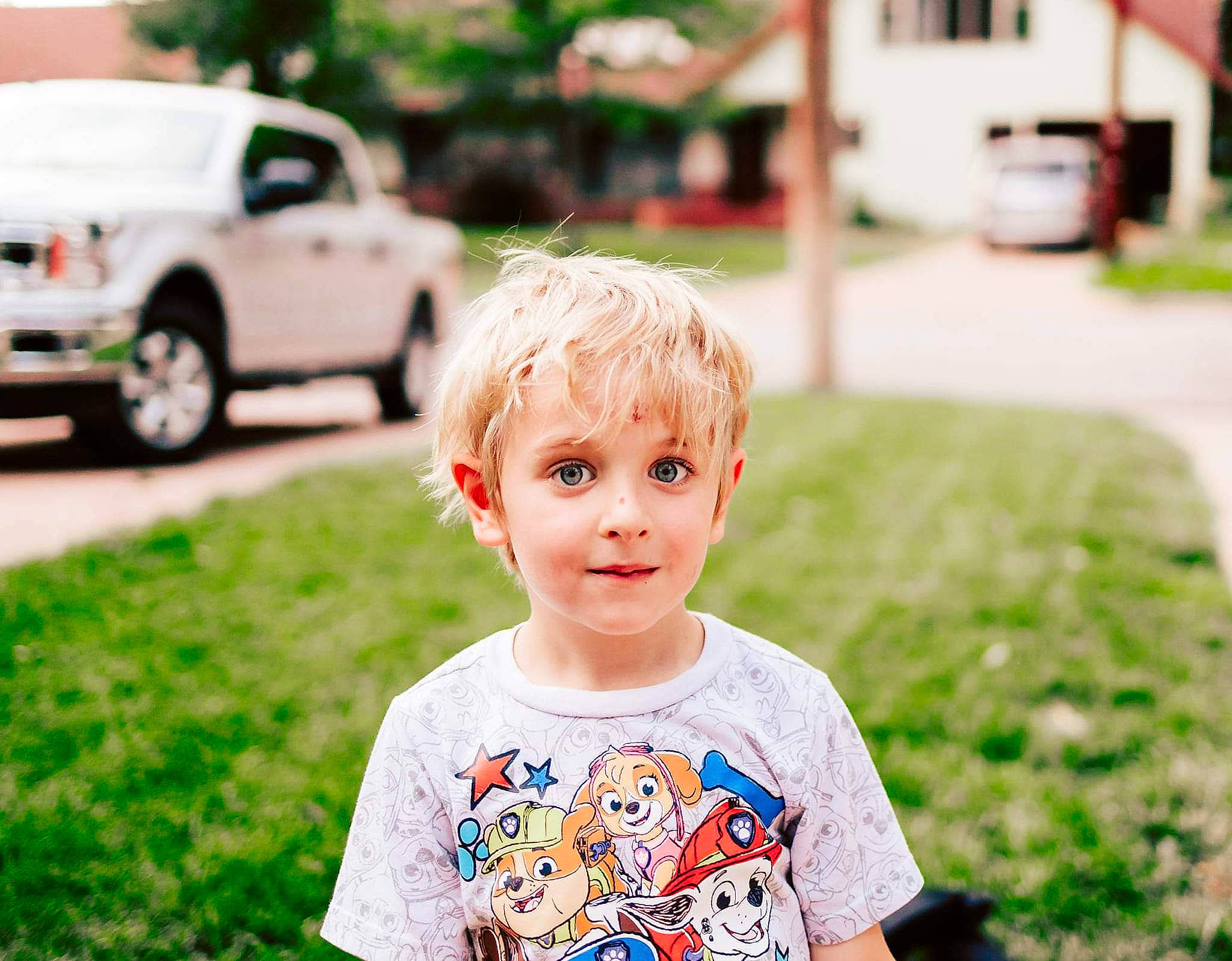 James is registered to the contest to win money with this photo: car, child, fun, grass, green, happy, iris, leisure, light, people, people_in_nature, person, photograph, plant, summer, tire, toddler, vehicle, wheel, white