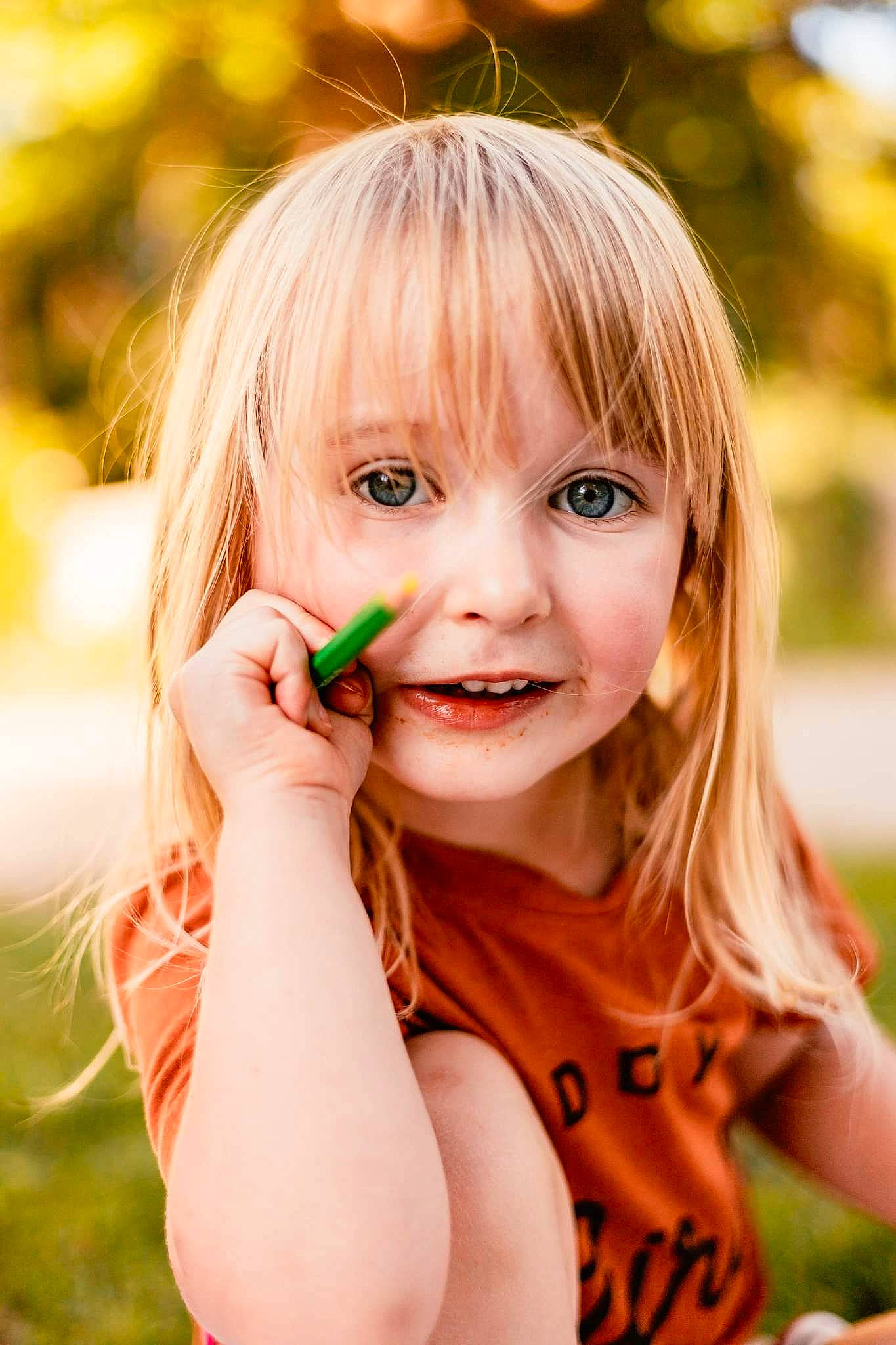 Josephine is registered to the contest to win money with this photo: bangs, blond, child, eyelash, face, flash_photography, gesture, grass, happy, iris, joy, layered_hair, lip, long_hair, people_in_nature, person, plant, skin, smile, summer