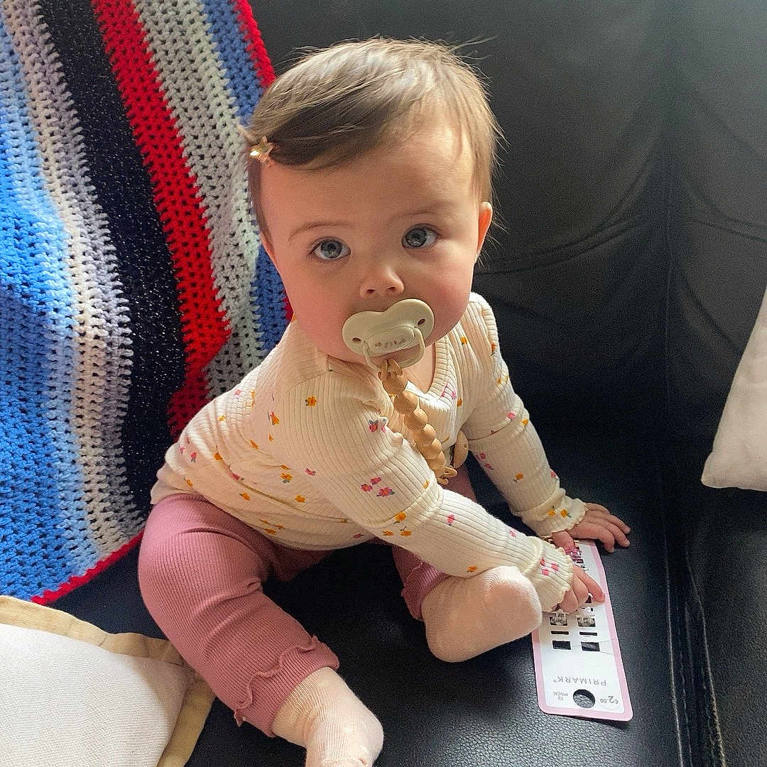 Miya is registered to the contest to win money with this photo: accessories, architecture, baby, bed, bedroom, blanket, blonde, bodypart, bracelet, building, clothing, coffeetable, couch, crawling, cushion, electronics, face, finger, footwear, formalwear