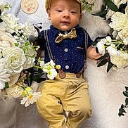 Theodore joined the competition — help win amazing prizes! baby, infant, child, flower_arrangement, white_flowers, yellow_flowers, blanket, bow_tie, cap, suspenders, pants, cute, portrait, celebration, mother's_day, soft_texture, laying_down, happy, decorative, outdoor_style
