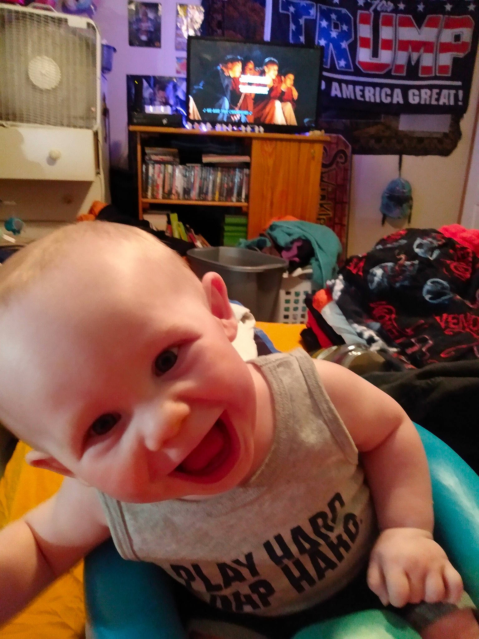 Anakin is registered to the contest to win money with this photo: baby, baby_toddler_clothing, blue, blurred, cheek, child, chin, finger, fun, happy, leisure, mouth, muscle, nose, person, product, skin, smile, snapshot, television