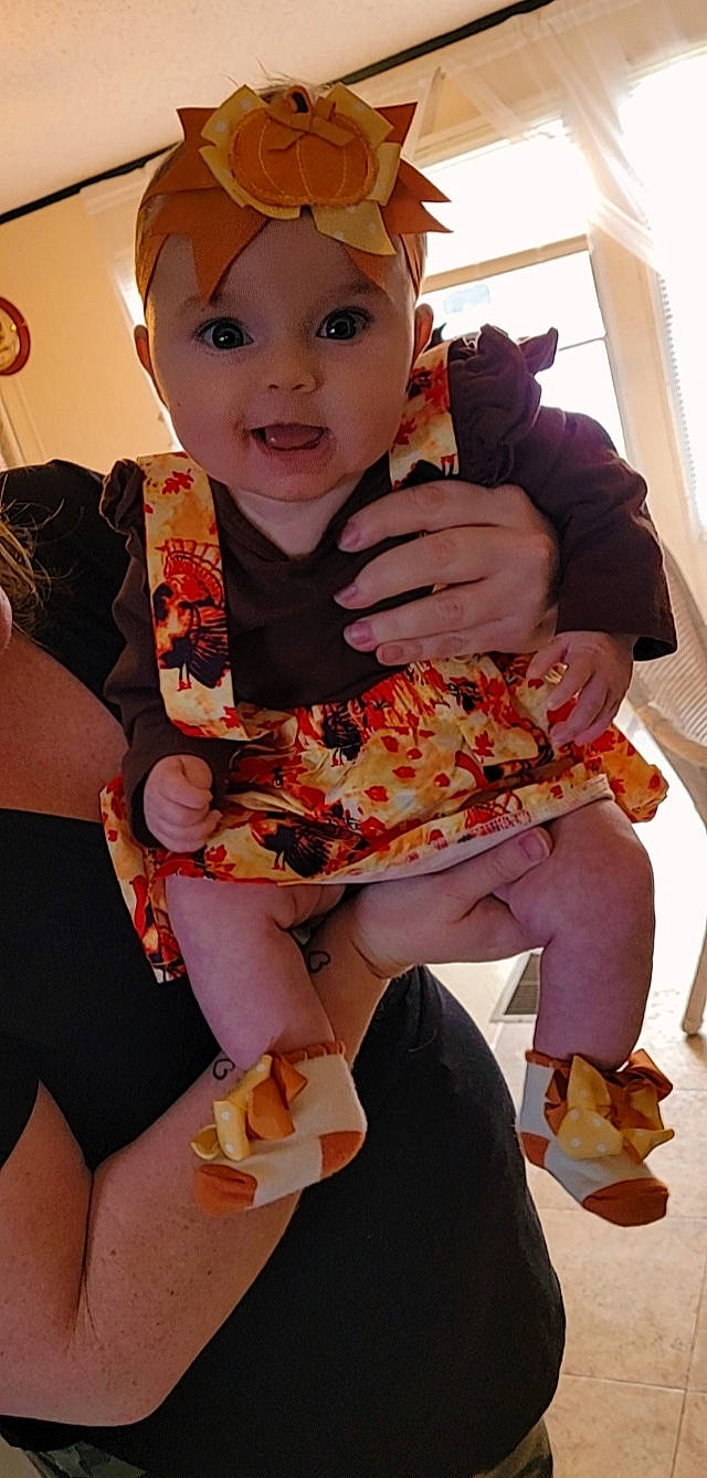 Anara joined the competition — help win amazing prizes! baby, chair, child, costume, cuisine, dish, fashion_design, finger, food, fun, headwear, human_leg, ingredient, junk_food, orange, organ, pattern, peach, person, sitting