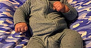 Kayden is registered to the contest to win money with this photo: baby, infant, pacifier, blanket, pajamas, green_clothing, lying_down, cute, indoors, child, cozy, face, person, newborn, toddler, patterned_blanket, sleepwear, small_hands, expression, resting