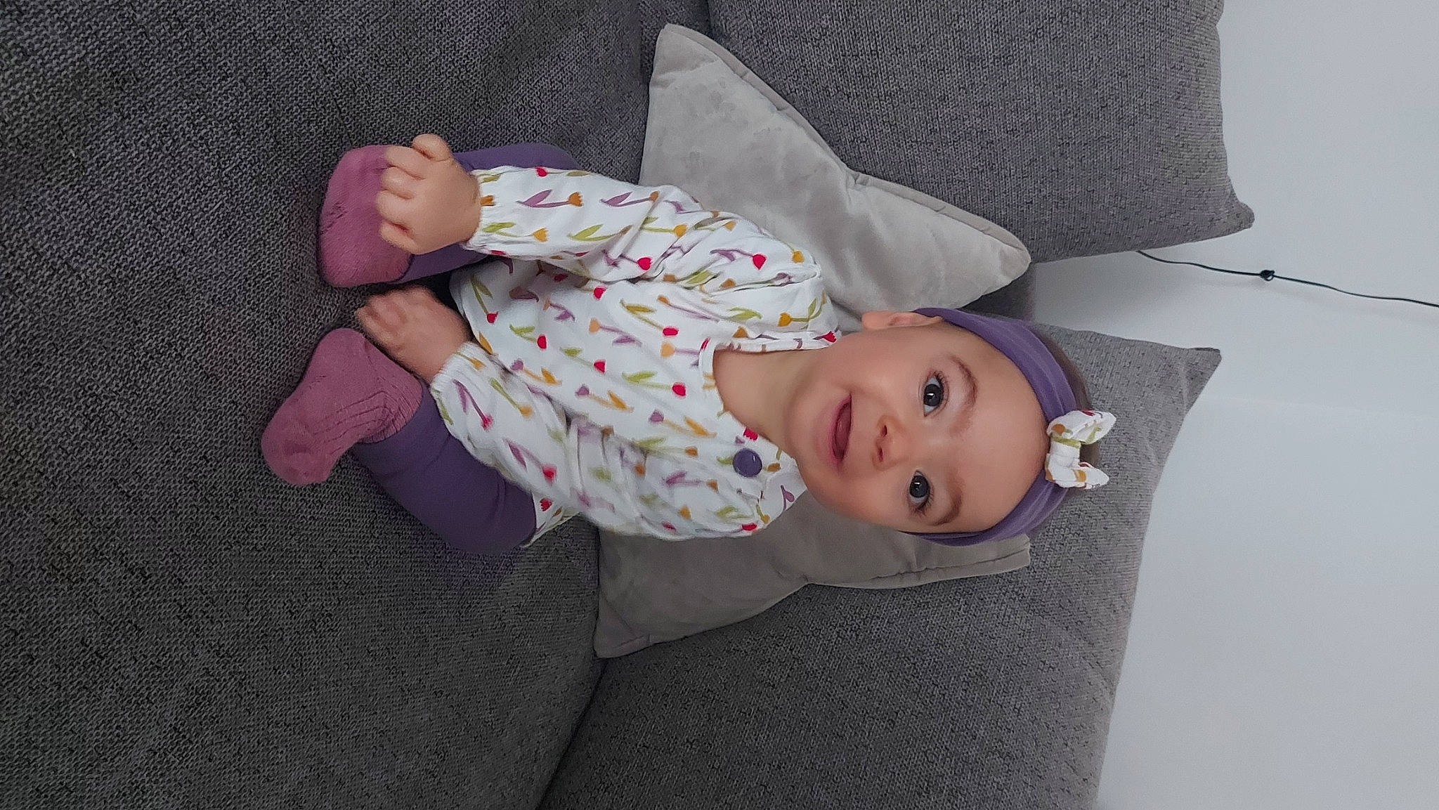 Annaëlle a rejoint le concours — aidez-le/la à gagner de superbes lots ! baby, baby_products, baby_toddler_clothing, child, comfort, flooring, hat, headwear, linens, pattern, person, pink, product, room, sitting, sleeve, toddler, wood