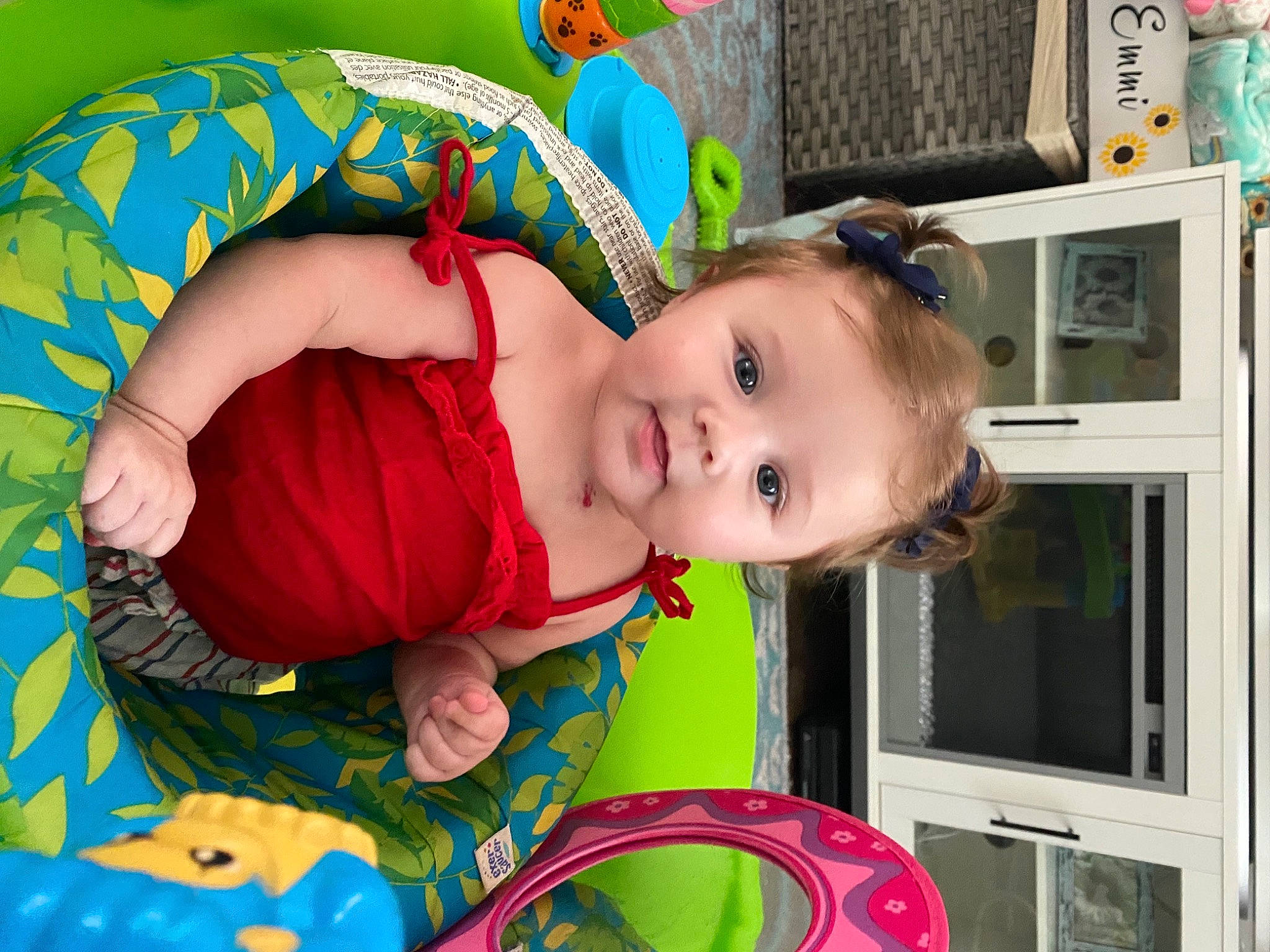 Emmi is registered to the contest to win money with this photo: baby, baby_products, baby_toddler_clothing, baby_toys, cheek, child, facial_expression, fun, green, happy, iris, person, photograph, picture_frame, pink, play, room, skin, smile, snapshot
