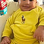 Zion joined the competition — help win amazing prizes! baby, child, yellow_clothing, smile, indoor, chair, cushion, face, hand, person, baby_clothes, comfort, seated, cute, home, furniture, portrait, infant, happy, casual