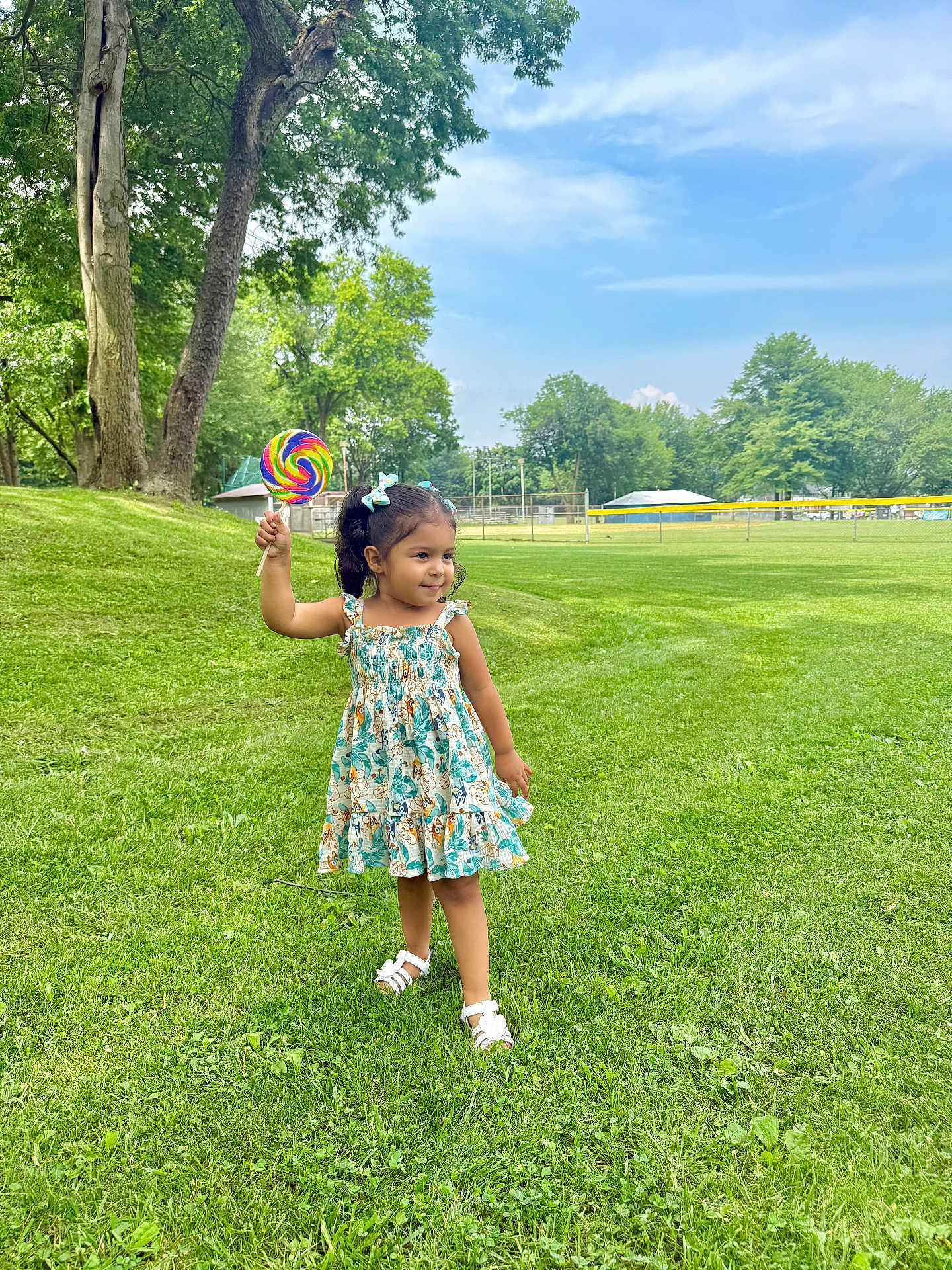 Asia joined the competition — help win amazing prizes! child, girl, lollipop, dress, grass, outdoor, park, trees, smiling, happy, summer, nature, play, footwear, sky, greenery, sunlight, cute, youth, recreation