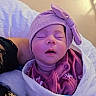newborn, baby, sleeping, portrait, face, hat, bow, purple, blanket, bundled, infant, closed_eyes, peaceful, indoors, bed, textile, clothing, parent, cozy, photography