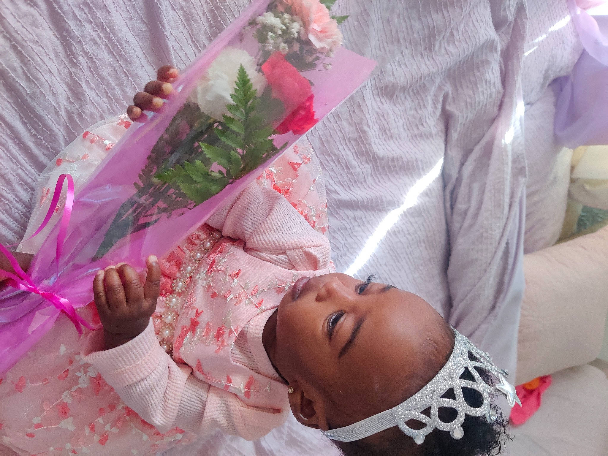 Delaney is registered to the contest to win money with this photo: baby, baby_toddler_clothing, child, comfort, dress, flesh, happy, linens, magenta, pattern, peach, person, petal, pink, plant, room, smile, toddler