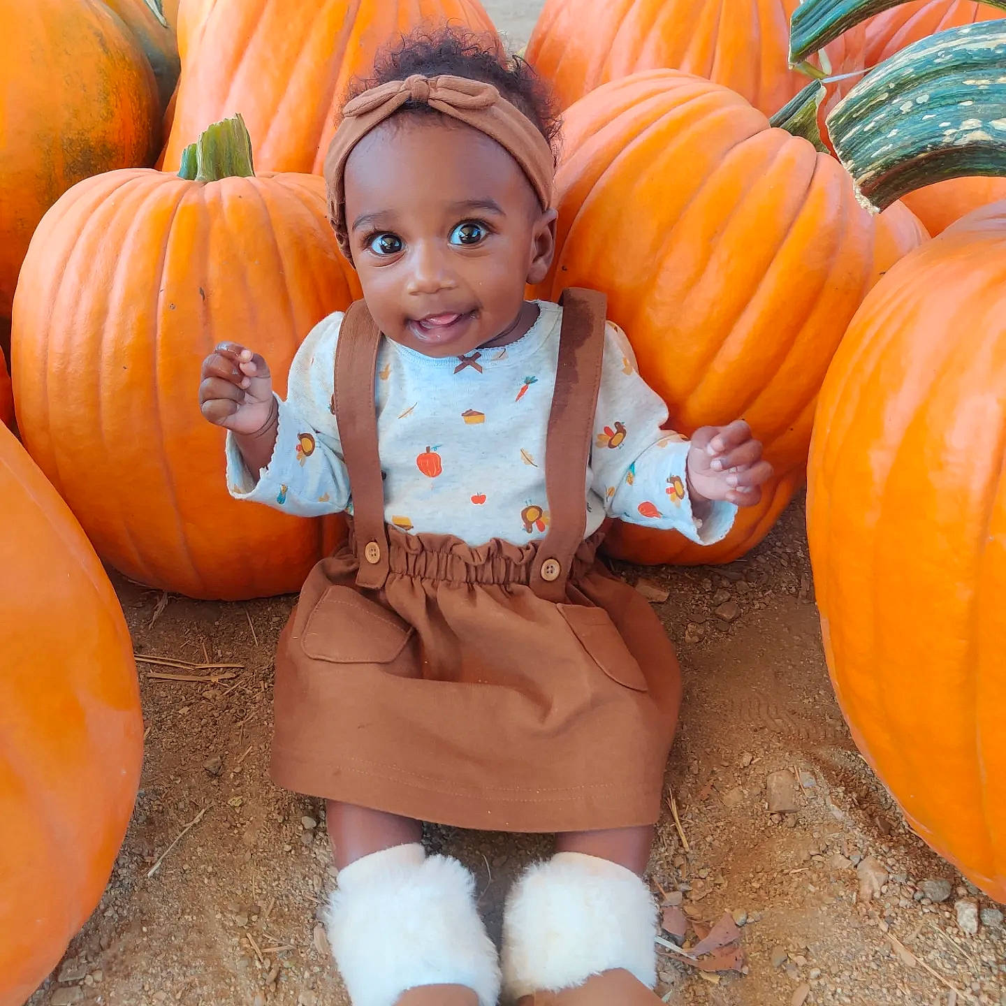 Delaney is registered to the contest to win money with this photo: baby_toddler_clothing, calabaza, cucurbita, eye, gourd, grass, happy, head, joy, natural_foods, orange, organ, people, people_in_nature, person, photograph, plant, pumpkin, smile, squash