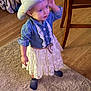 toddler, child, cowboy_hat, dress, lace, blue_shirt, socks, carpet, wooden_floor, chair, home_interior, curious, standing, indoor, clothing, person, floor, playful, hat, young_child