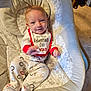 Izabella is registered to the contest to win money with this photo: baby, infant, valentines_day, bib, clothing, baby_seat, cushion, footed_pajamas, patterned_clothes, smile, face, person, indoor, carpet, blanket, cute, newborn, baby_garment, lying_down, comfort