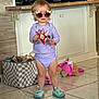 toddler, sunglasses, purple_clothing, indoor, toy, floor_tile, snack, television, storage_bin, plush_toy, shoes, person, child, candid, living_room, cute, playtime, young_child, home, smiling