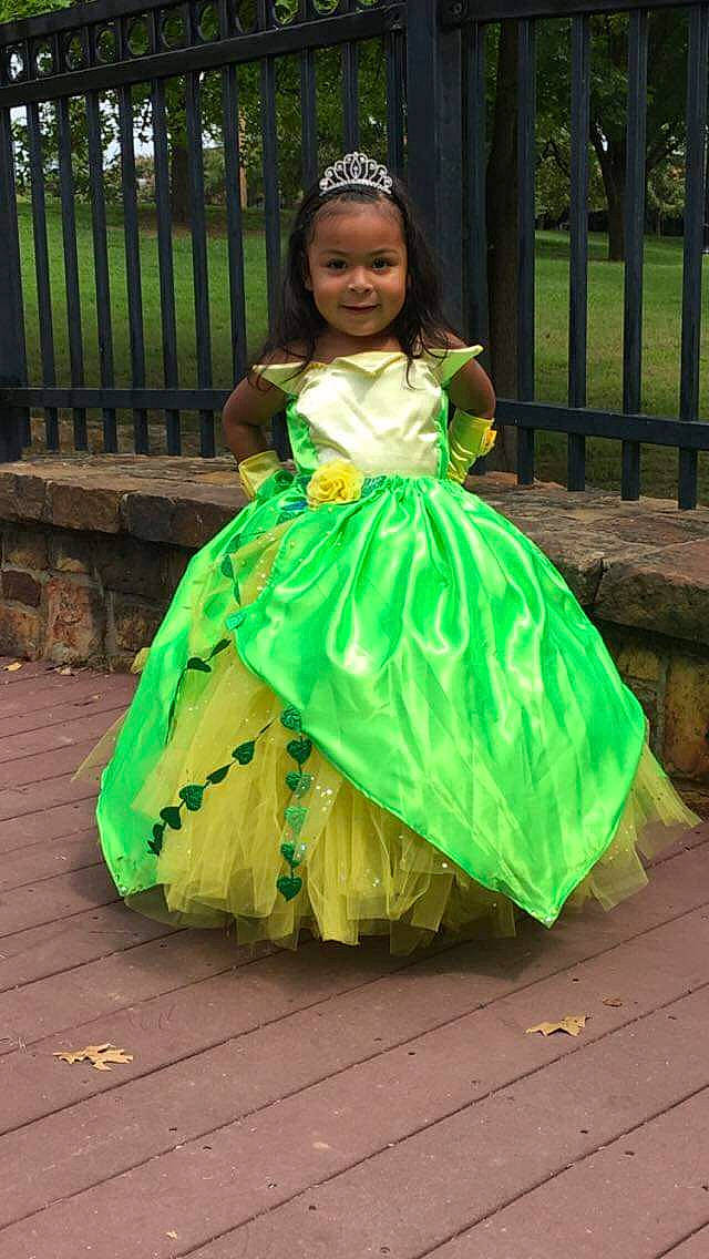 Melina joined the competition — help win amazing prizes! child, dress, event, eye, face, fence, formal_wear, fun, gown, grass, hairstyle, happy, headpiece, joy, leisure, person, plant, recreation, ruffle, smile