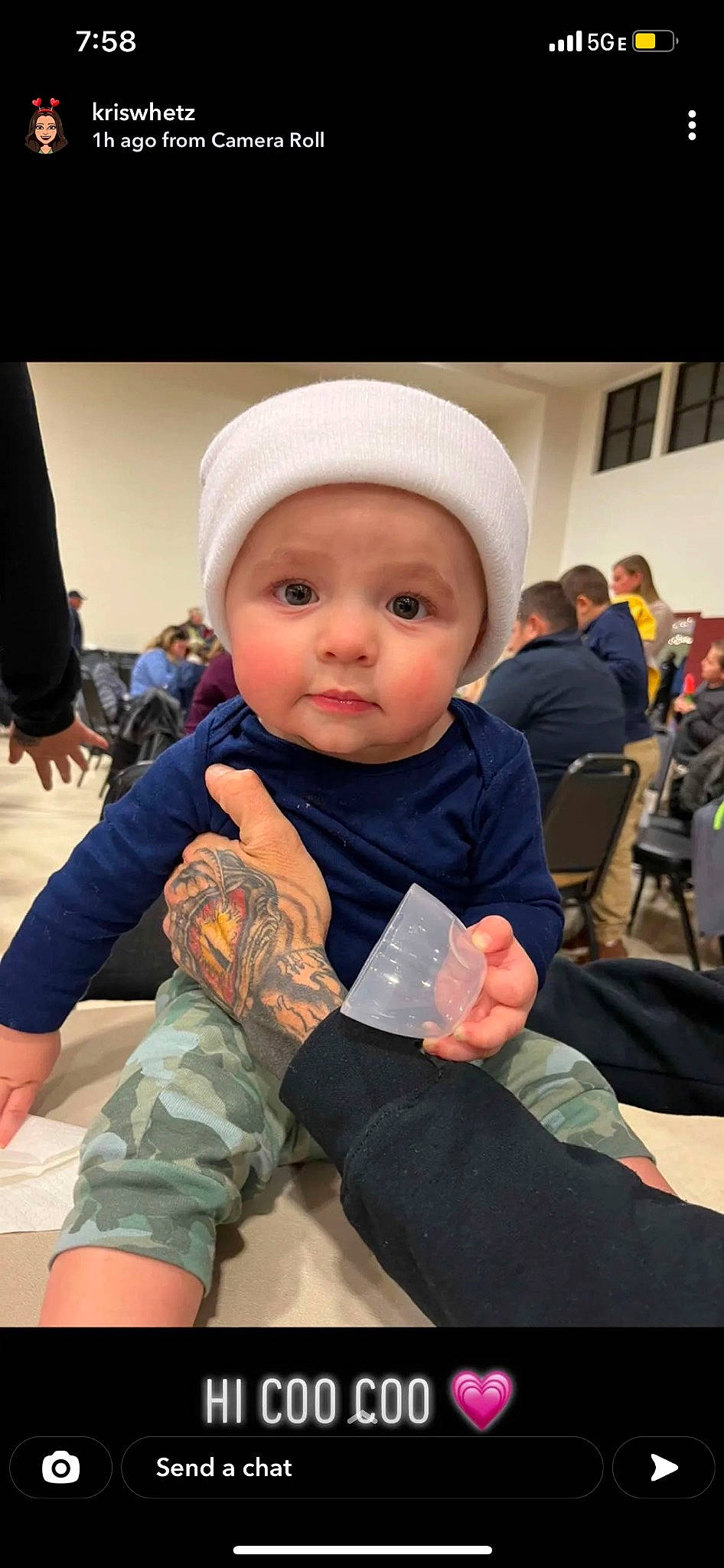 Jax is registered to the contest to win money with this photo: baby, baby_toddler_clothing, blurred, camouflage, cap, child, comfort, event, fashion_accessory, flooring, fun, headwear, military_camouflage, person, personal_protective_equipment, room, sitting, skin, sock, toddler