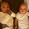 Jamiah is registered to the contest to win money with this photo: baby, infant, child, toddler, onesie, diaper, lying_down, cute, expression, pout, curious, indoor, person, two_babies, skin, face, hand, head, sleepwear, floor