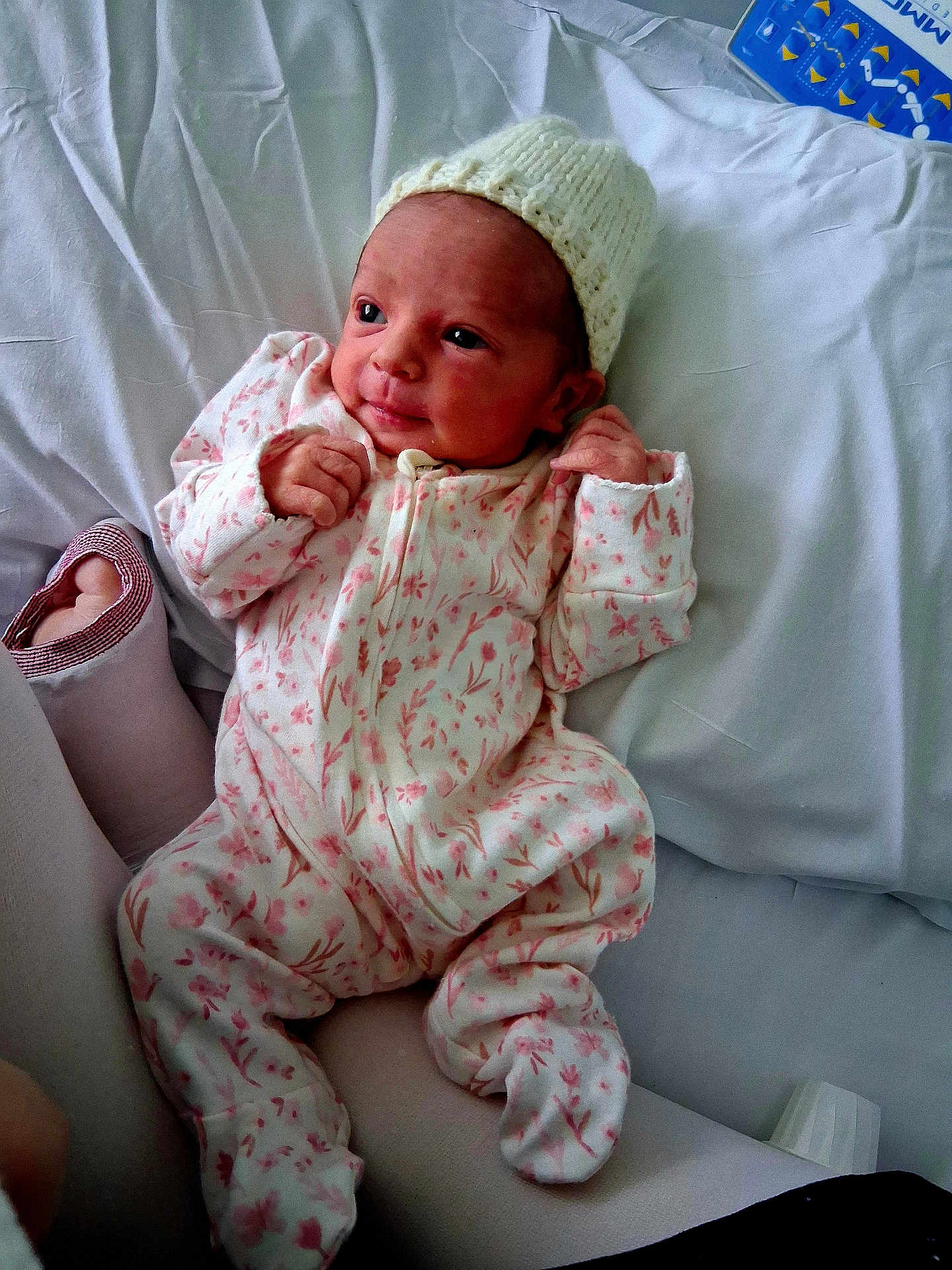 Raya is registered to the contest to win money with this photo: newborn, baby, infant, onesie, hat, blanket, lying_down, cozy, cute, soft, sleepy, portrait, child, person, indoors, fabric, pink, white, comfortable, small