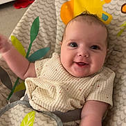 River is registered to the contest to win money with this photo: baby, bodypart, bonnet, clothing, cushion, face, finger, furniture, hand, happy, hat, head, homedecor, newborn, person, photography, portrait, sitting, smile, t_shirt