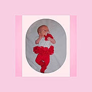 Zhelda is registered to the contest to win money with this photo: baby, infant, pacifier, red_clothing, tutu, leggings, blanket, soft_texture, lying_down, cute, child, portrait, indoors, pink_border, white_background, clothing, newborn, hands, face, head